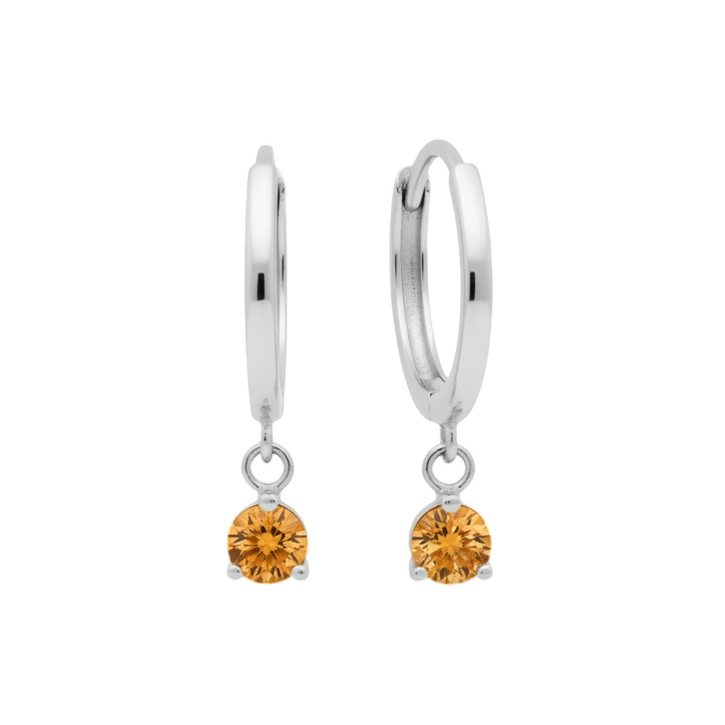 Qutahia Jewelry 14k solid gold dangling huggie earrings with orange citrine gemstones in a claw setting.