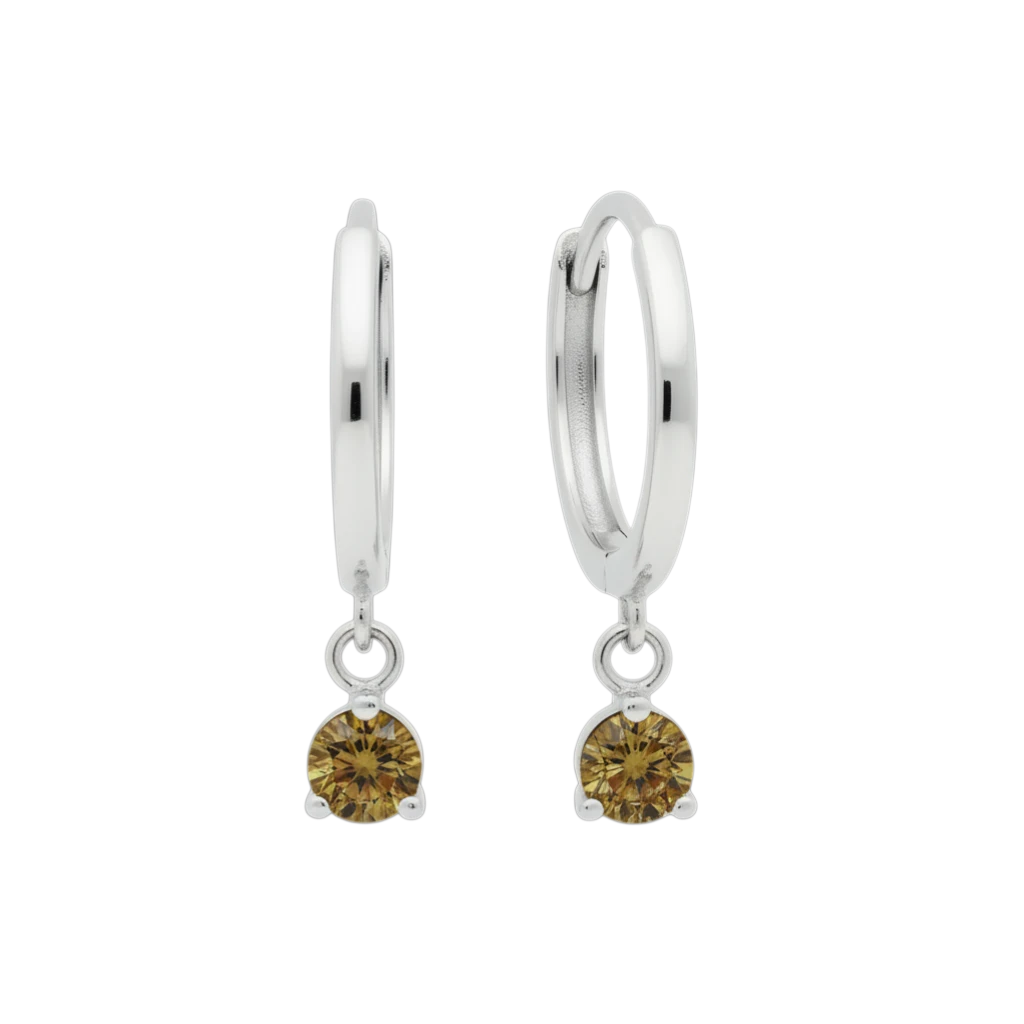 Qutahia Jewelry 14k solid gold dangling huggie earrings with claw-set yellow-green gemstones.