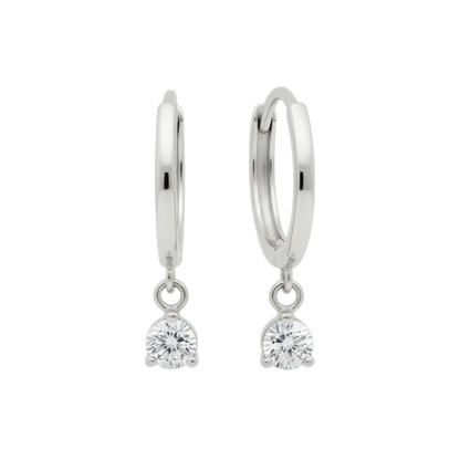 Qutahia Jewelry 14k solid gold dangling huggie earrings with clear claw-set solitaire gemstone.