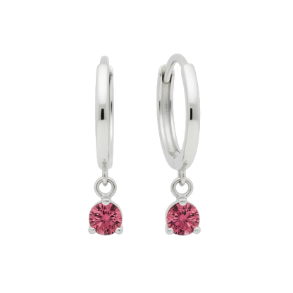 Qutahia Jewelry 14k solid gold dangling huggie earrings with pink gemstones in a claw setting.