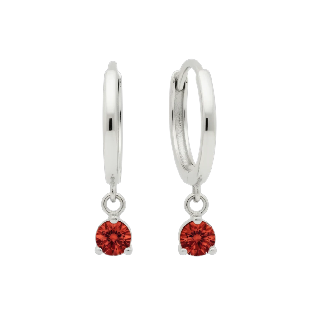 Qutahia Jewelry 14k solid gold dangling huggie earrings with red gemstone in claw setting.