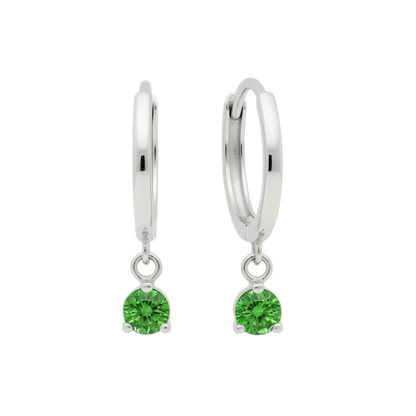 Qutahia Jewelry 14k solid gold huggie earrings with dangling green gemstone in claw setting.
